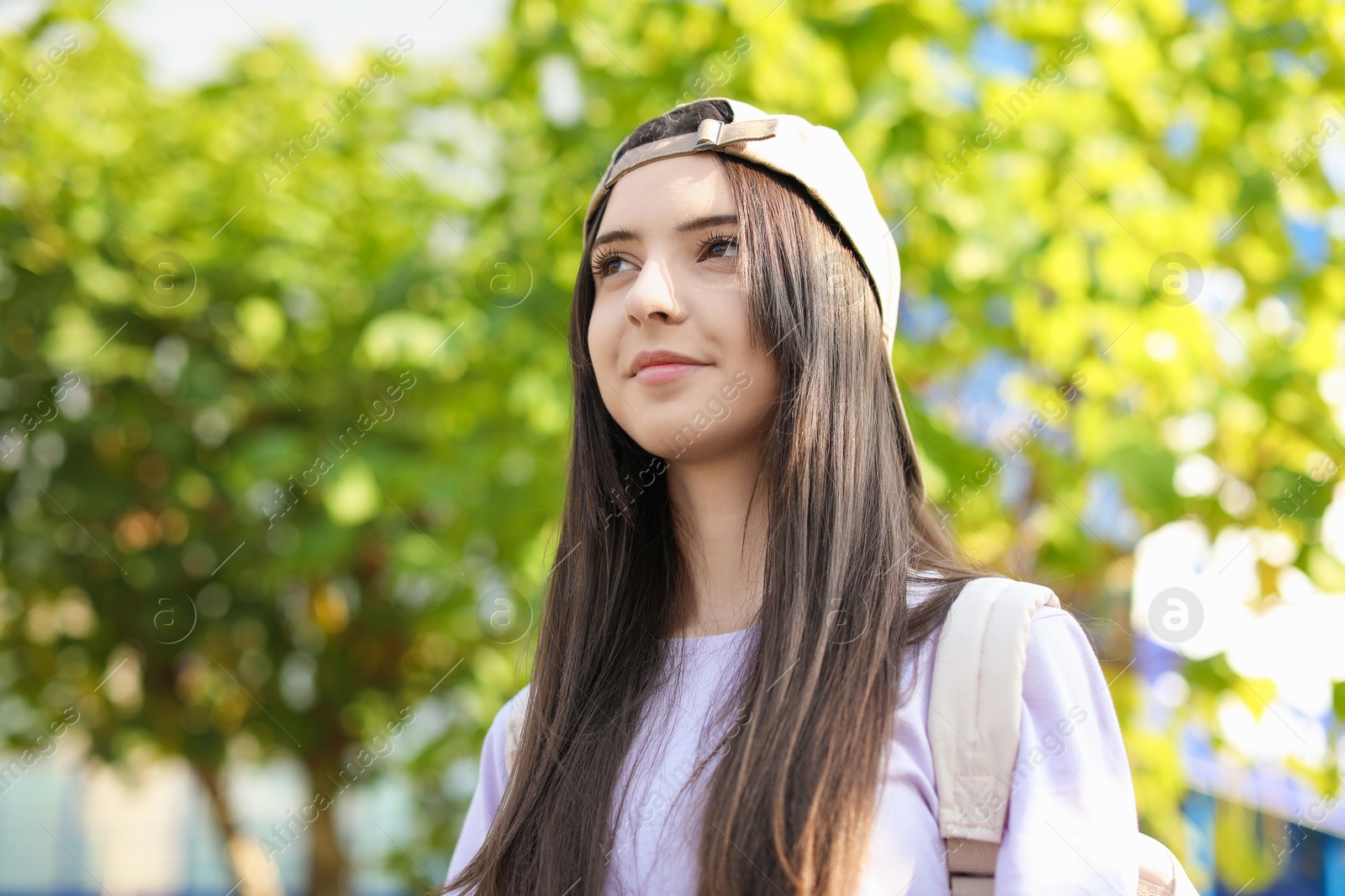 Photo of Portrait of teenage girl in stylish cap outdoors