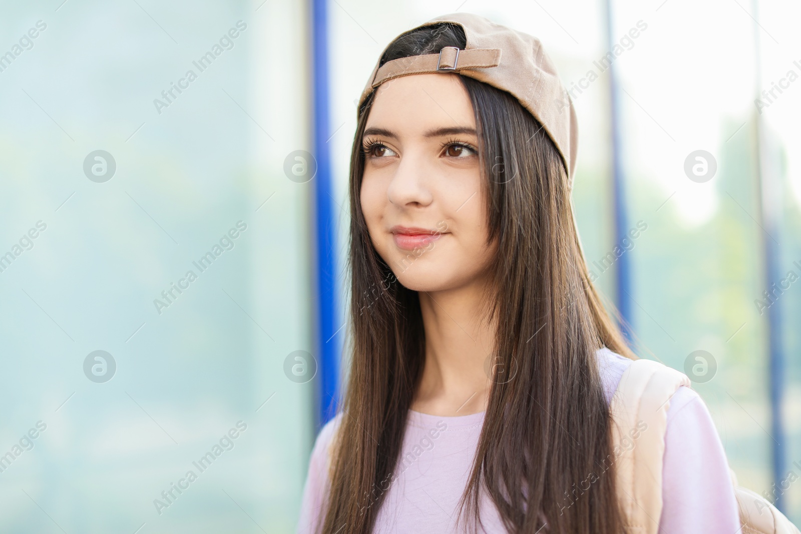 Photo of Portrait of teenage girl in stylish cap outdoors. Space for text