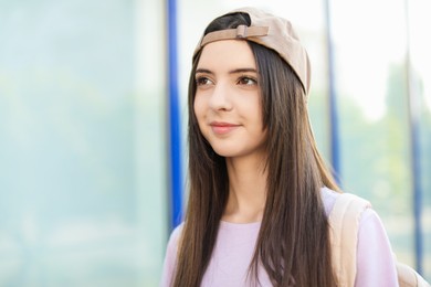 Photo of Portrait of teenage girl in stylish cap outdoors. Space for text