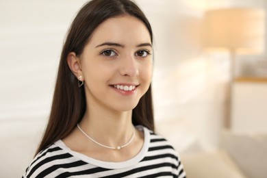 Photo of Portrait of smiling teenage girl at home