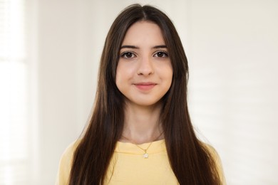 Photo of Portrait of beautiful teenage girl at home