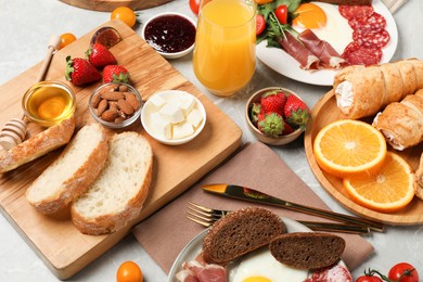 Photo of Different tasty food served for brunch on grey marble table