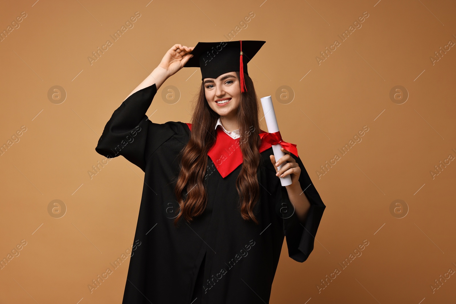 Photo of Happy student with diploma after graduation on beige background