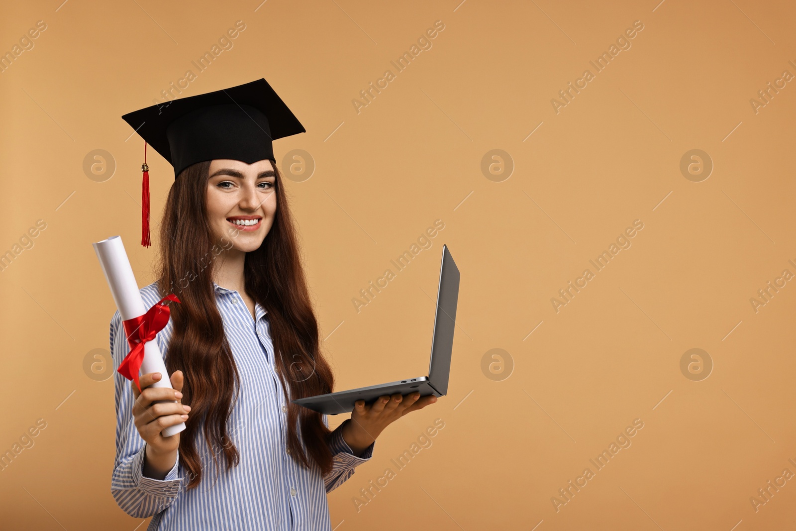 Photo of Happy student with diploma and laptop after graduation on beige background. Space for text