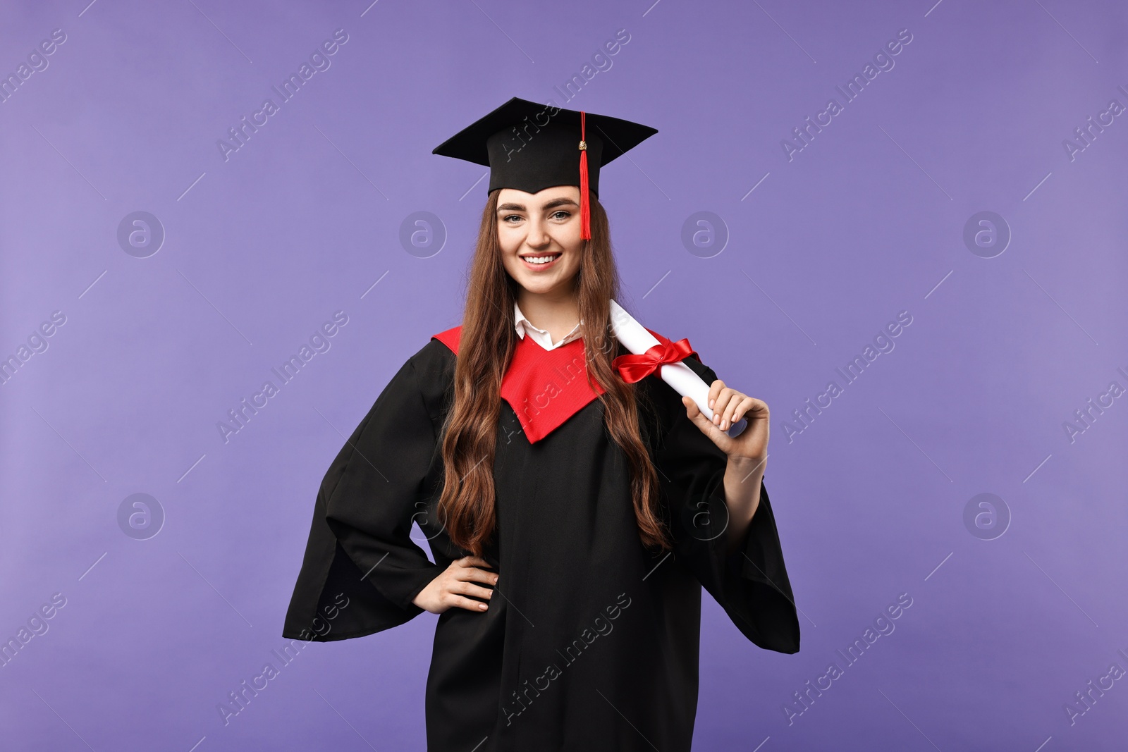 Photo of Happy student with diploma after graduation on violet background