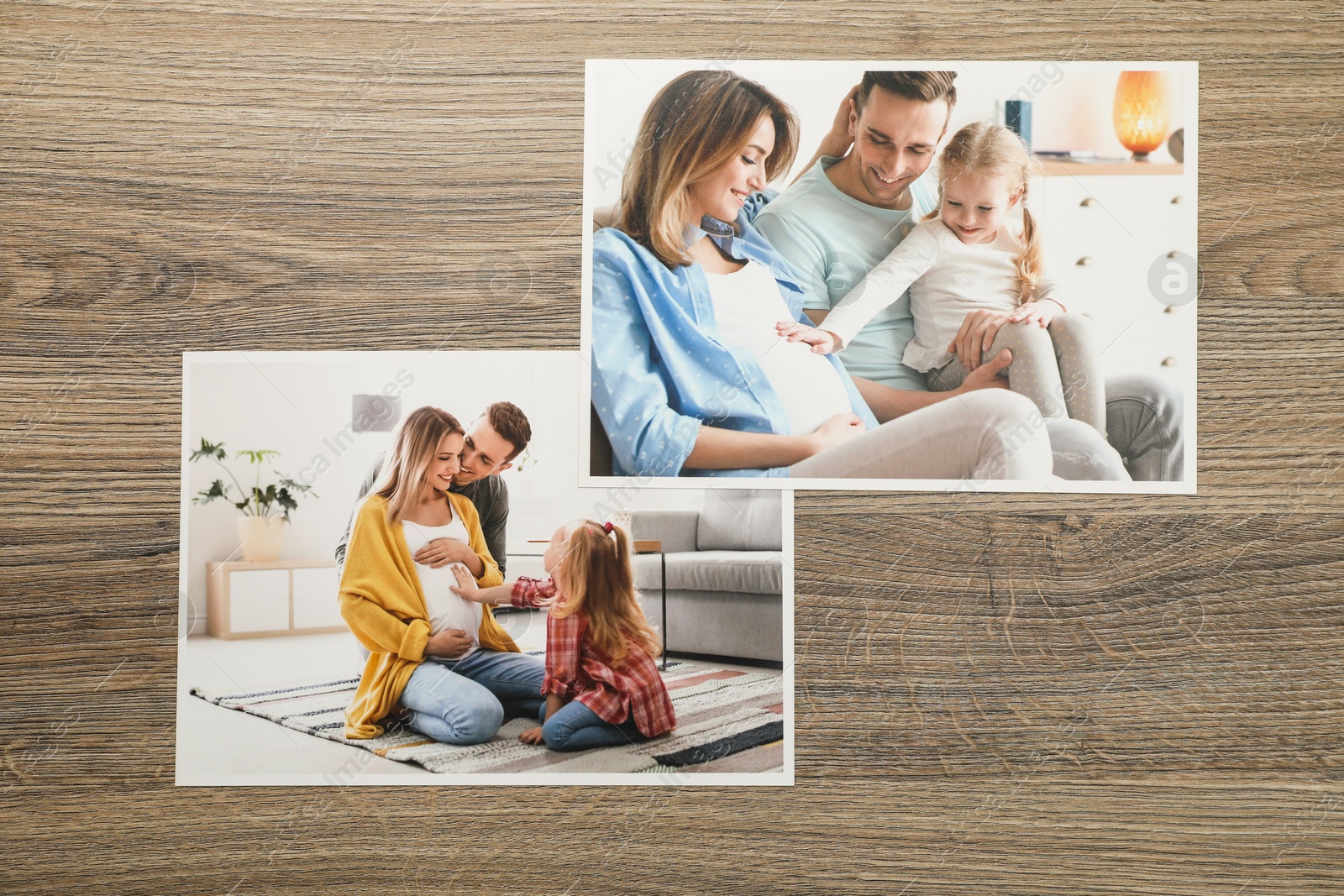 Photo of Different family photos on wooden table, flat lay