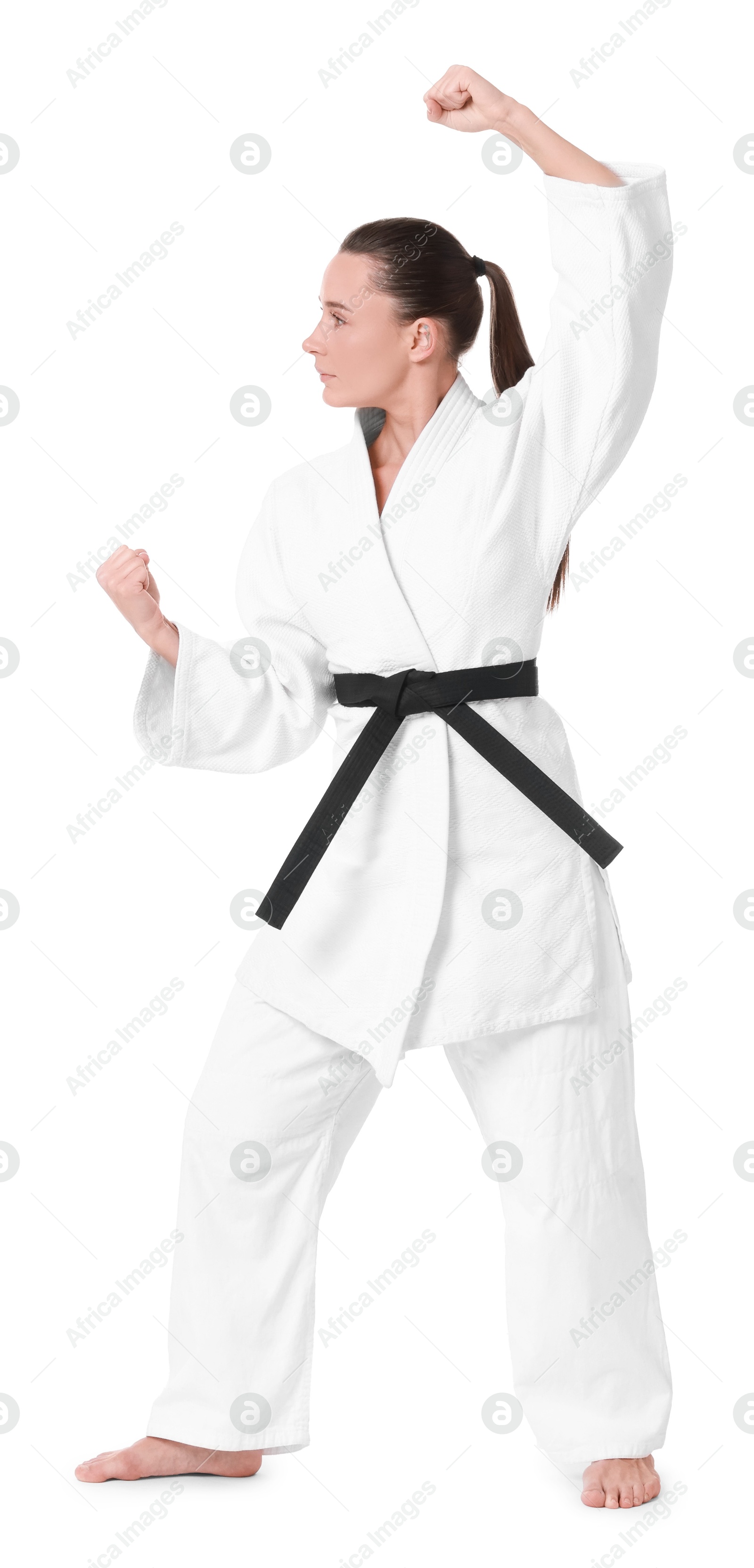 Photo of Young woman in kimono practicing karate on white background