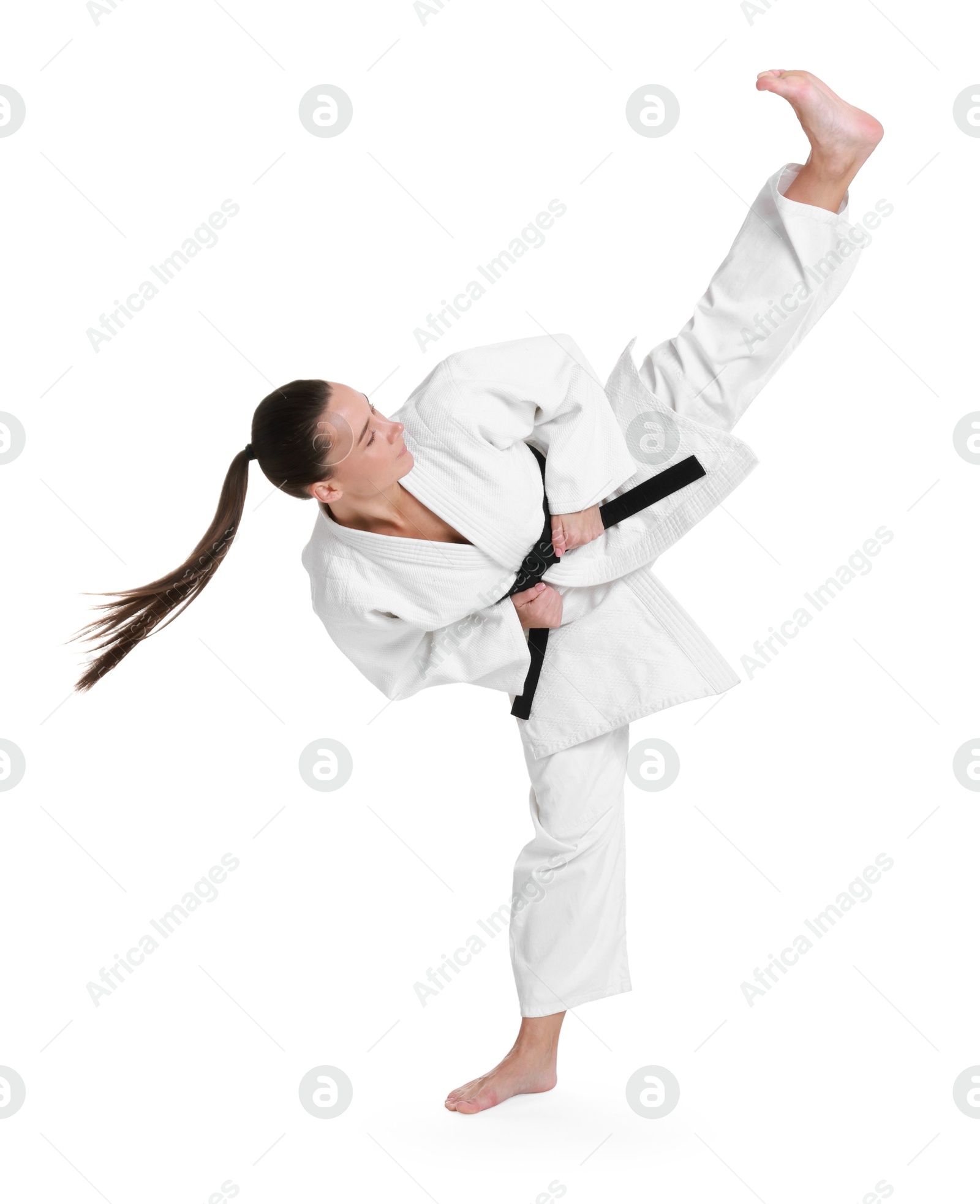 Photo of Young woman in kimono practicing karate on white background