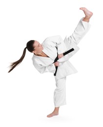 Photo of Young woman in kimono practicing karate on white background