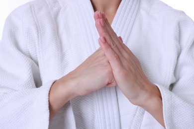 Photo of Karate fighter in kimono on white background, closeup