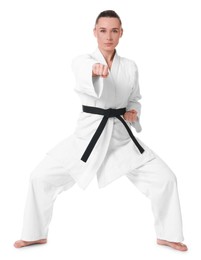 Photo of Young woman in kimono practicing karate on white background