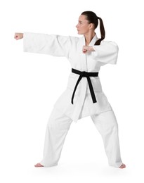 Photo of Young woman in kimono practicing karate on white background