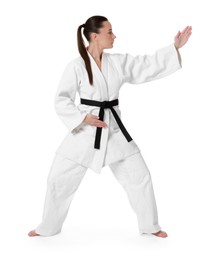 Photo of Young woman in kimono practicing karate on white background