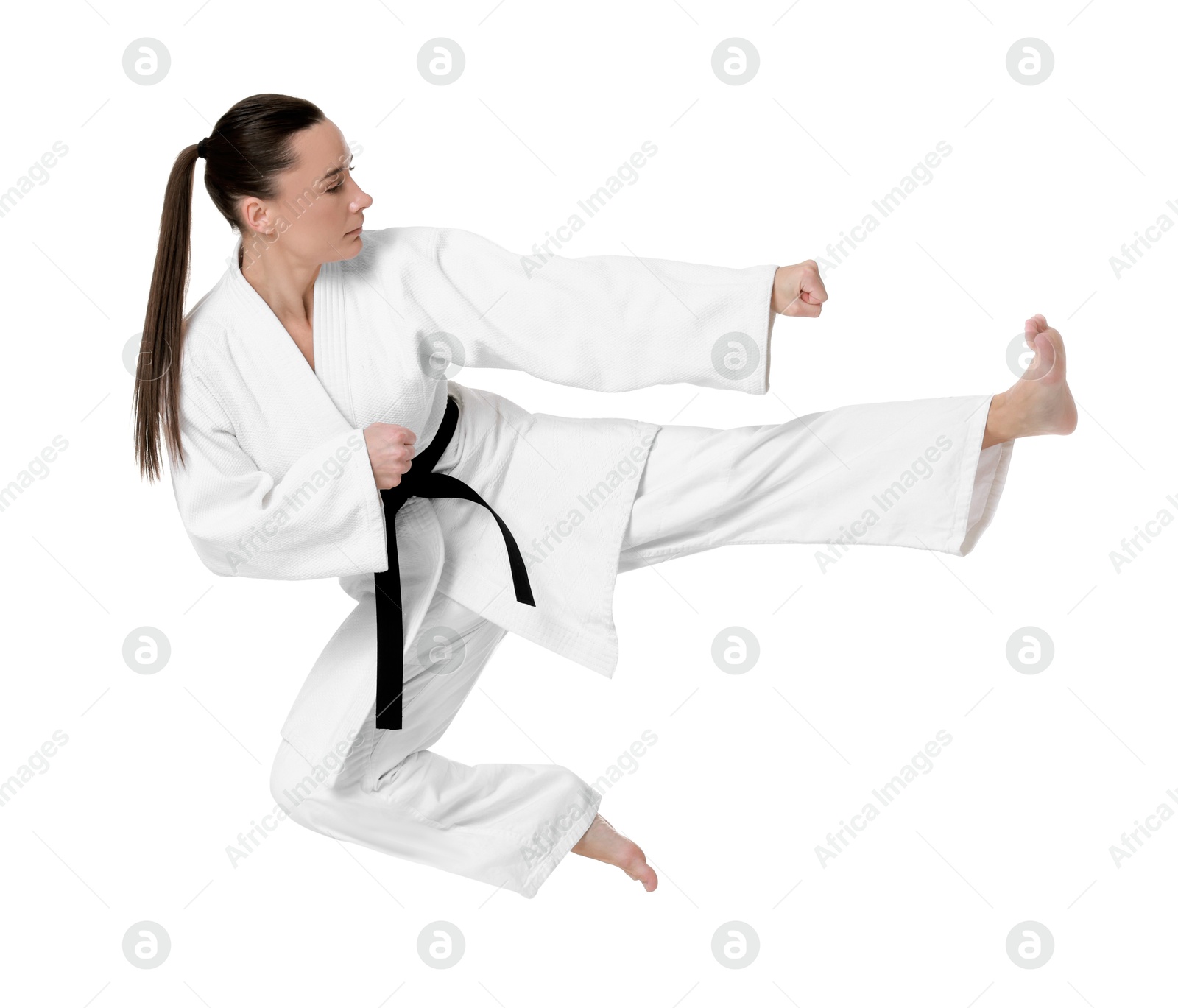 Photo of Young woman in kimono practicing karate on white background