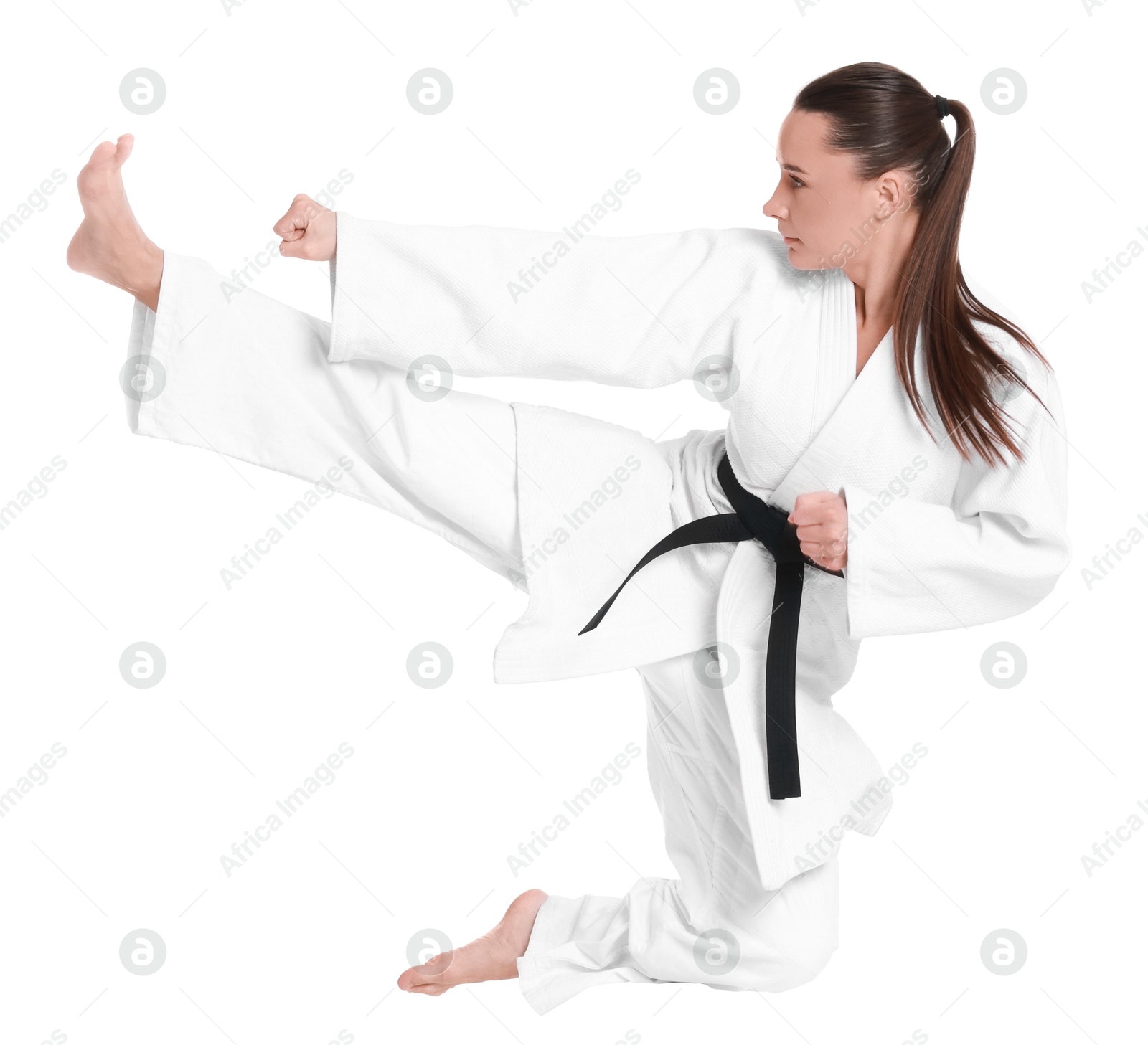 Photo of Young woman in kimono practicing karate on white background