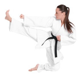 Photo of Young woman in kimono practicing karate on white background