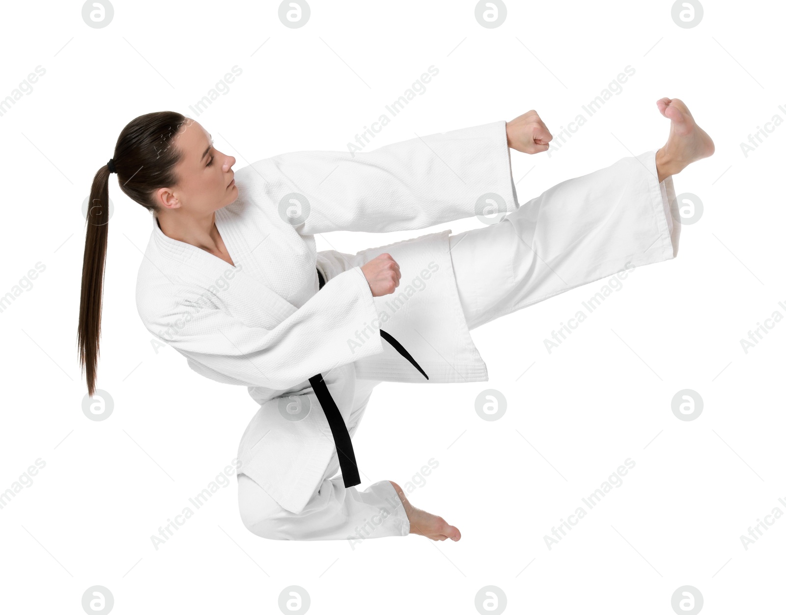 Photo of Young woman in kimono practicing karate on white background