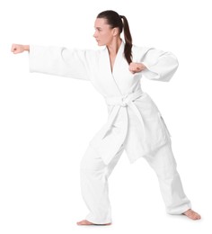 Photo of Young woman in kimono practicing karate on white background