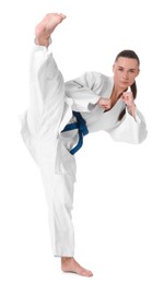 Photo of Young woman in kimono practicing karate on white background