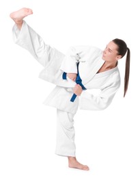 Photo of Young woman in kimono practicing karate on white background