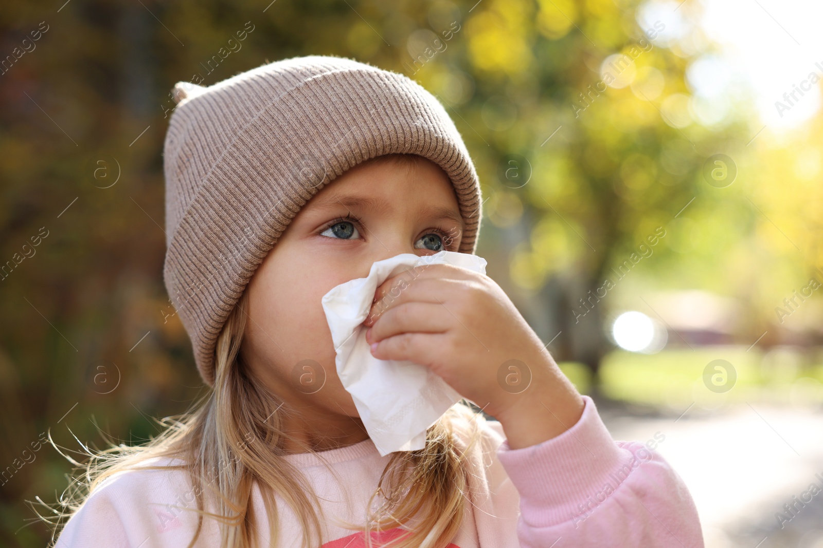 Photo of Little girl with runny nose in park