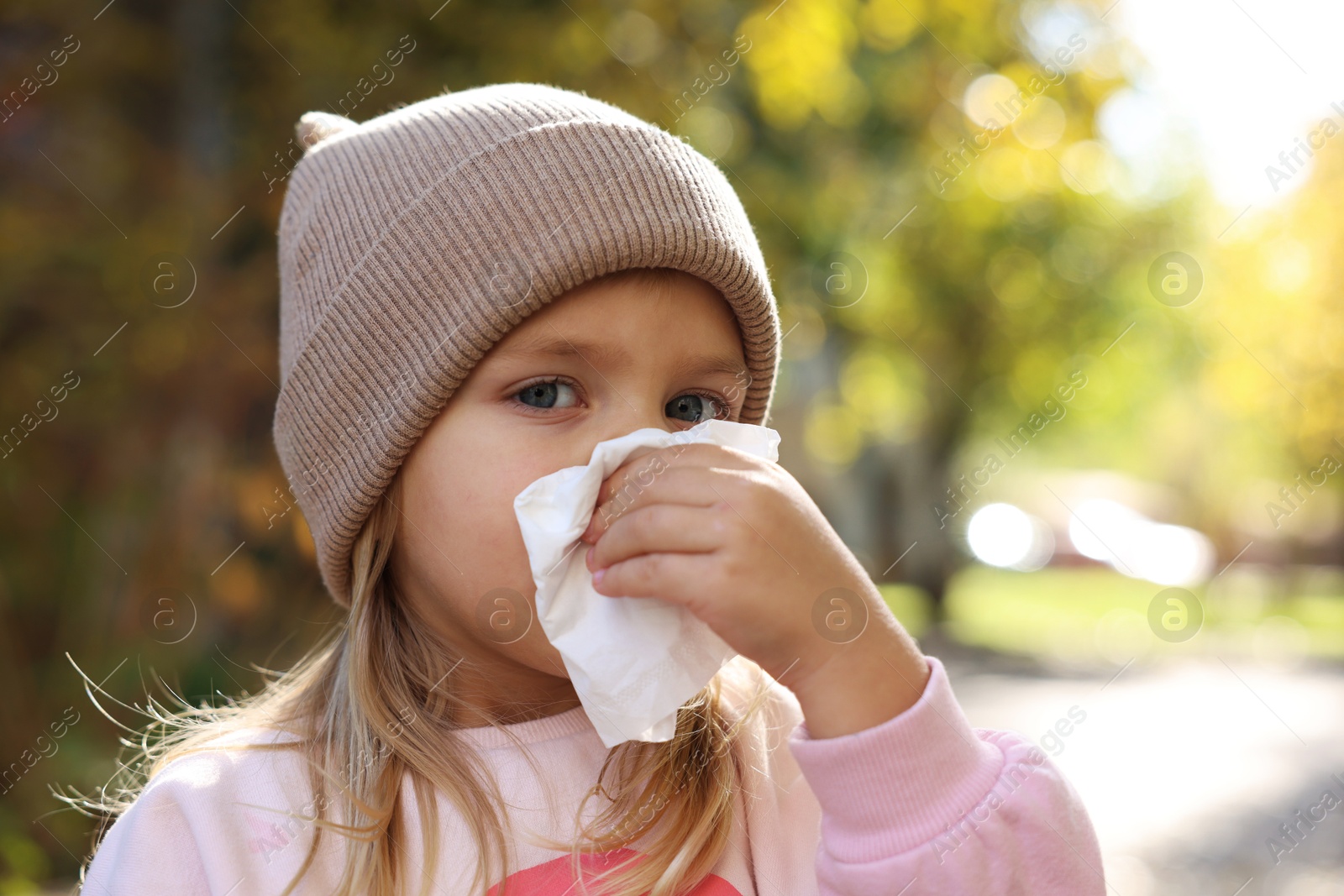 Photo of Little girl with runny nose in park