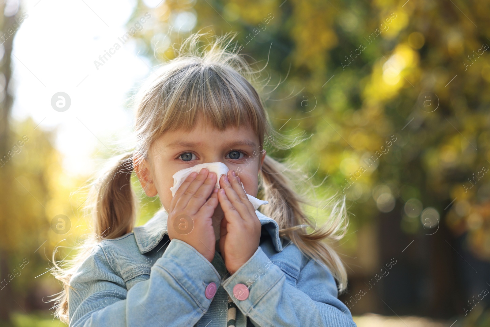 Photo of Little girl with runny nose in park