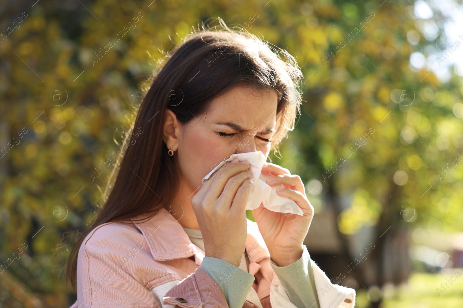 Photo of Young woman with runny nose in park