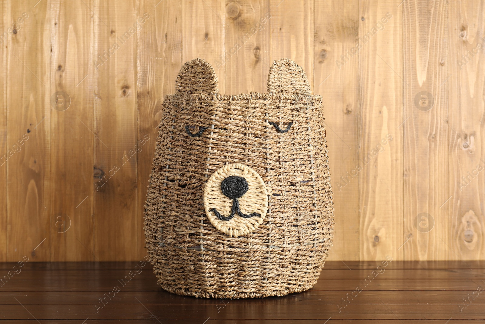 Photo of One wicker laundry basket on wooden table