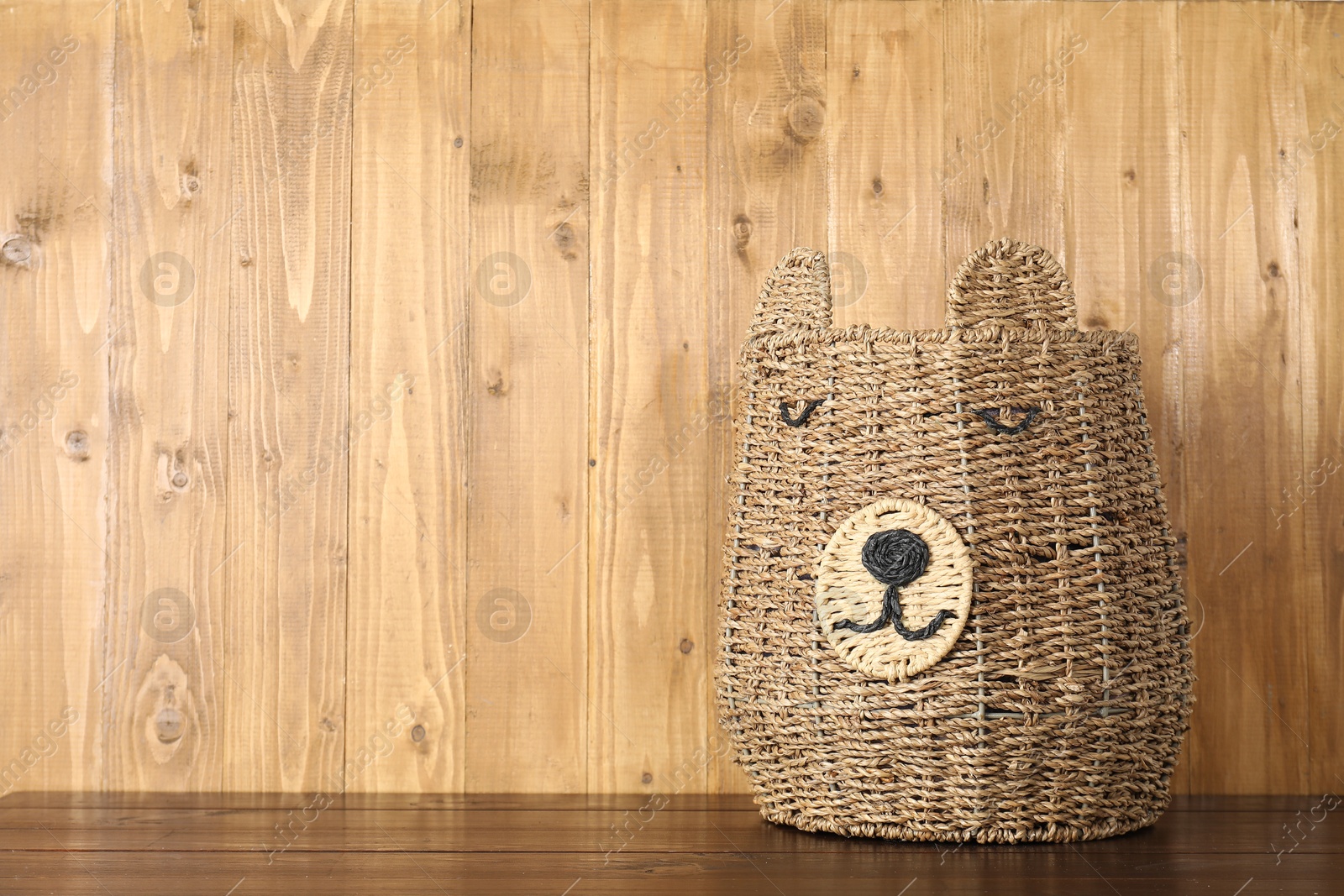 Photo of One wicker laundry basket on wooden table, space for text