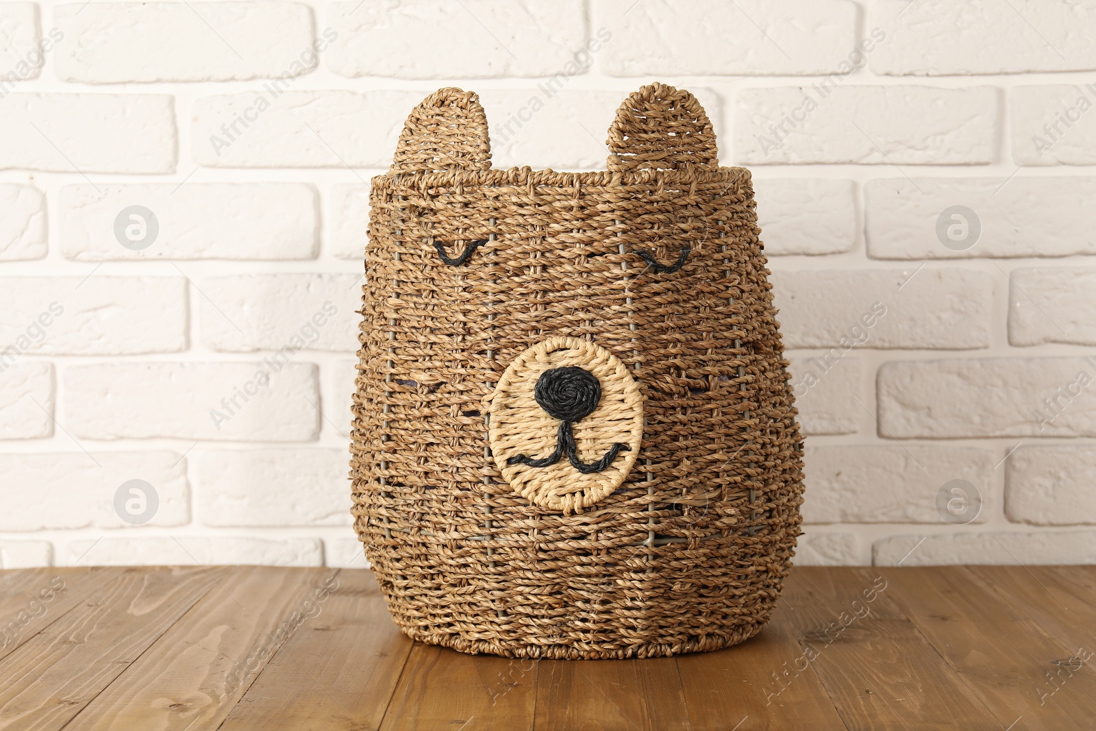 Photo of One wicker laundry basket on wooden table