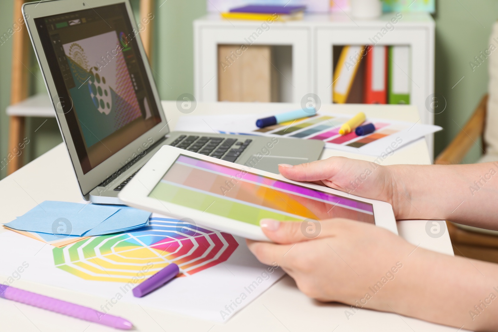 Photo of Website designer working at table indoors, closeup