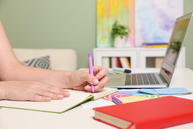 Photo of Website designer working at table indoors, closeup