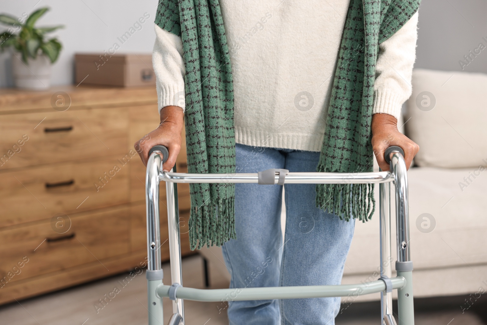 Photo of Senior woman with walking frame at home, closeup