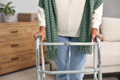 Photo of Senior woman with walking frame at home, closeup