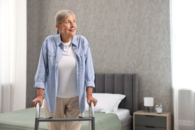 Photo of Senior woman with walking frame at home