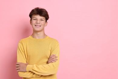 Photo of Portrait of happy teenage boy on pink background, space for text