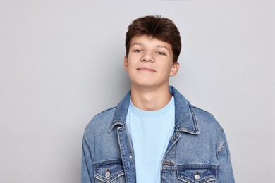 Photo of Portrait of teenage boy on light grey background