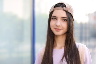 Photo of Portrait of teenage girl in stylish cap outdoors. Space for text