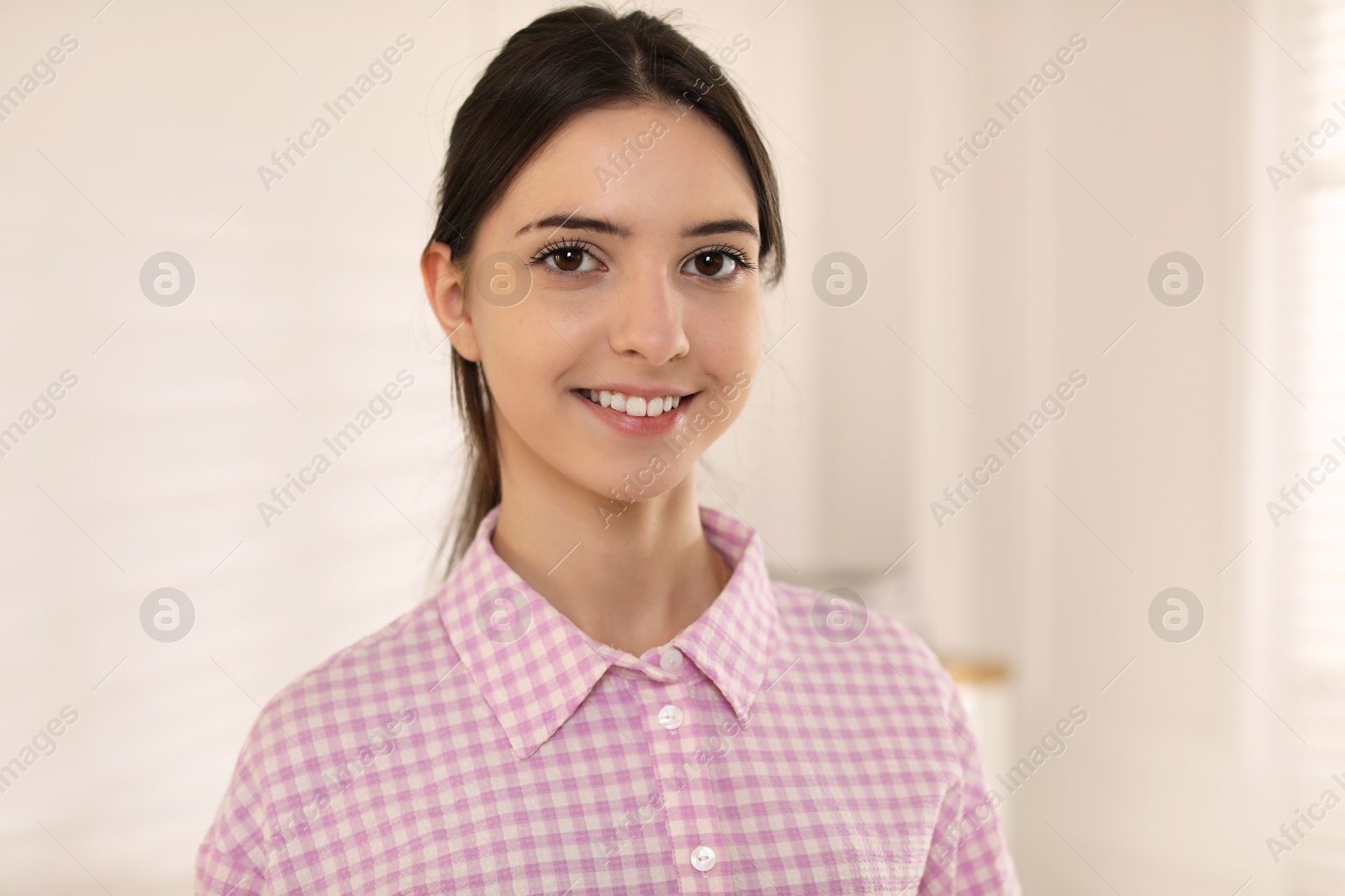 Photo of Portrait of beautiful teenage girl at home