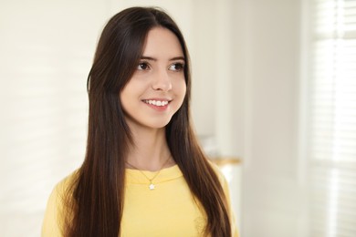 Photo of Portrait of happy teenage girl at home. Space for text