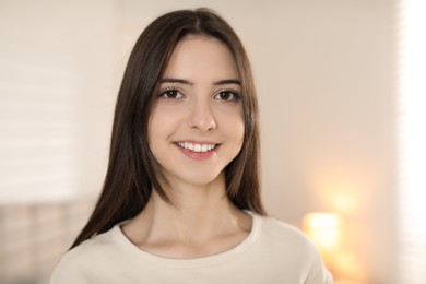 Photo of Portrait of happy teenage girl at home