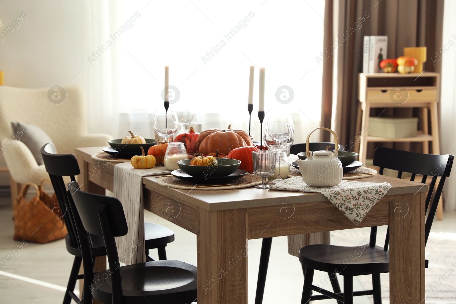 Photo of Stylish table setting with beautiful autumn decor in dining room