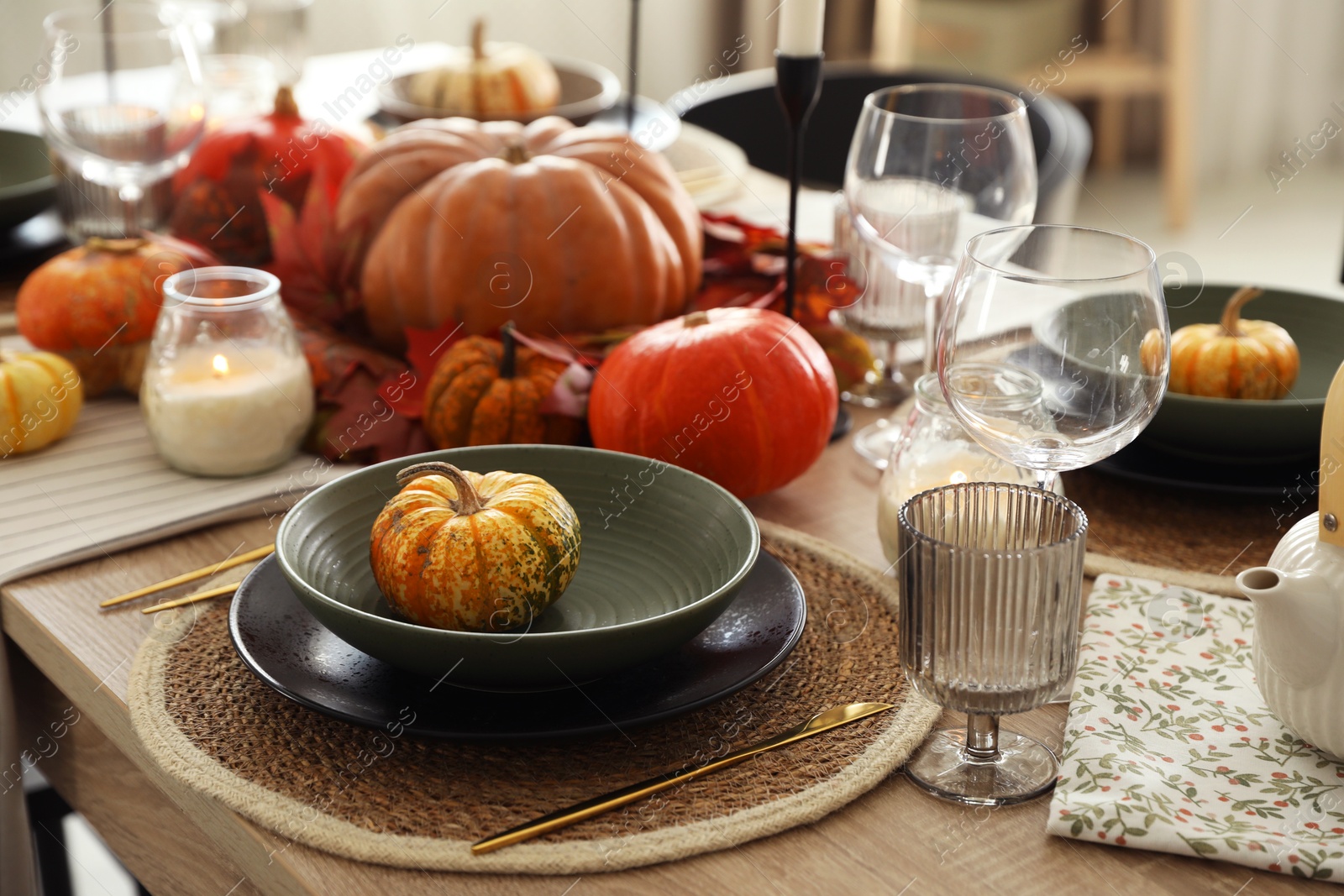 Photo of Stylish table setting with beautiful autumn decor in dining room