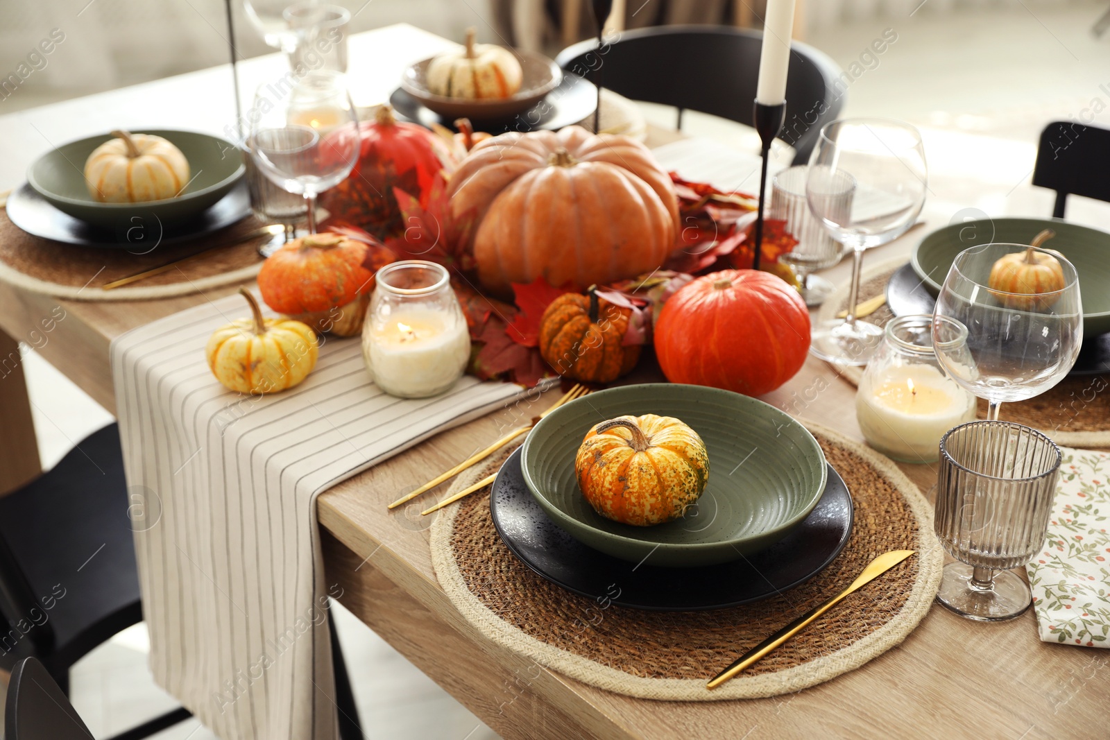 Photo of Stylish table setting with beautiful autumn decor in dining room