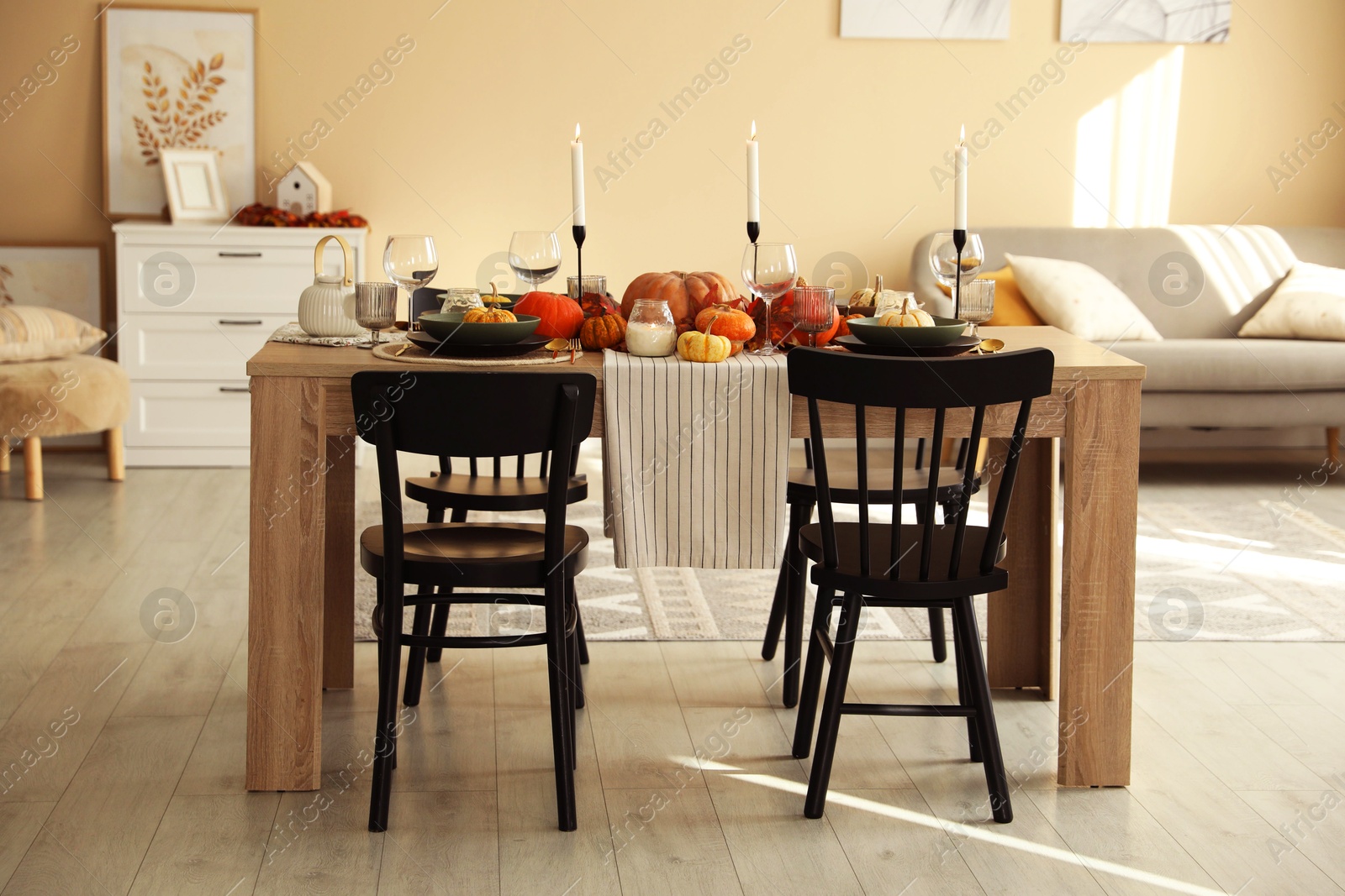 Photo of Stylish dining room with beautiful table setting and autumn decor