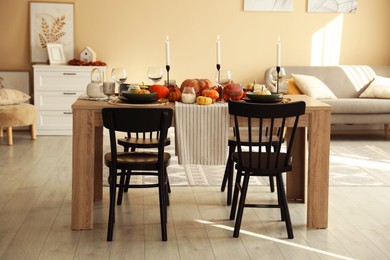 Photo of Stylish dining room with beautiful table setting and autumn decor