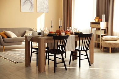 Photo of Stylish dining room with beautiful table setting and autumn decor