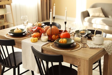 Photo of Stylish table setting with beautiful autumn decor in dining room