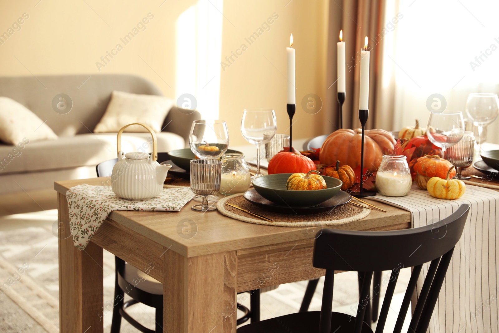 Photo of Stylish table setting with beautiful autumn decor in dining room